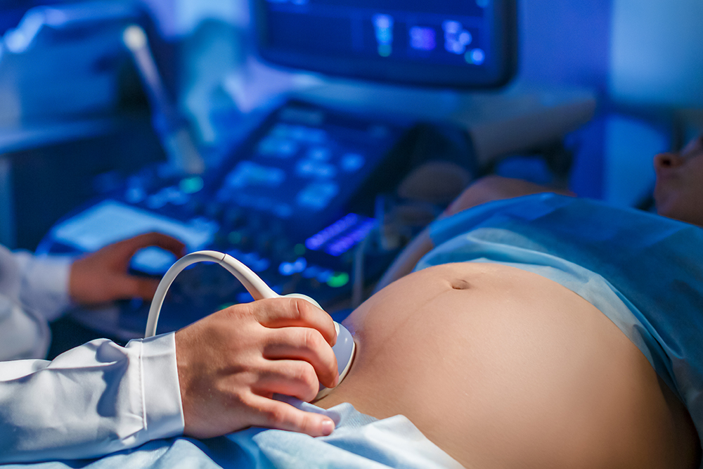 doctor-makes-ultrasound-scan-pregnant-woman-looks-screendrives-apparatus